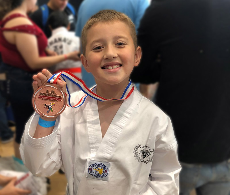 Young student celebrating achievement at Twin Tigers Taekwondo Oxnard - Kids martial arts success in Oxnard